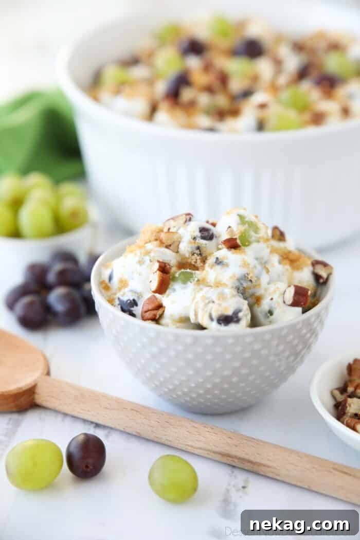 Creamy Grape Salad Recipe with Crunchy Pecans and Sweet Dressing 2 Creamy grape salad in an individual bowl topped with chopped pecans and brown sugar.