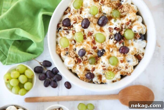 Creamy Grape Salad Recipe with Crunchy Pecans and Sweet Dressing 8 Red and green grapes in a fluffy cream cheese sauce topped with brown sugar and pecans.