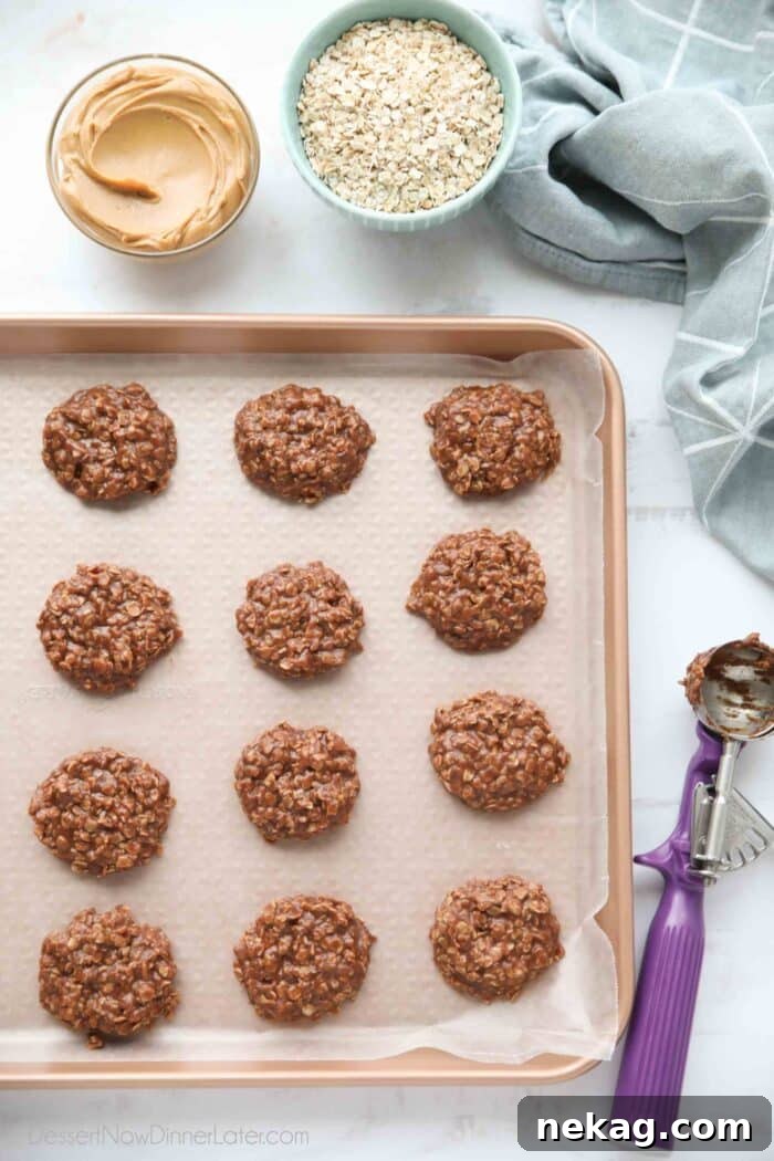 No bake cookies scooped onto a baking sheet with wax paper.