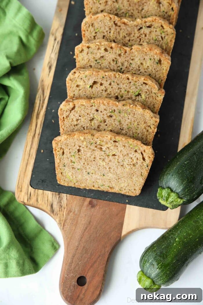 Slices of moist zucchini bread on a tray.