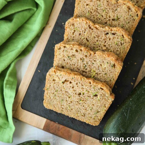 Slices of soft zucchini bread on a serving platter.