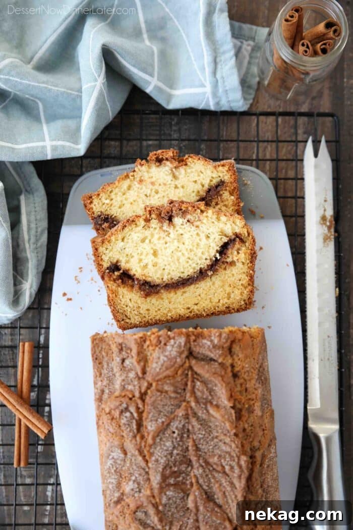 Ultimate Cinnamon Quick Bread Recipe — Moist & Spiced Loaf 3 Top view of cinnamon quick bread being sliced on a cutting board.