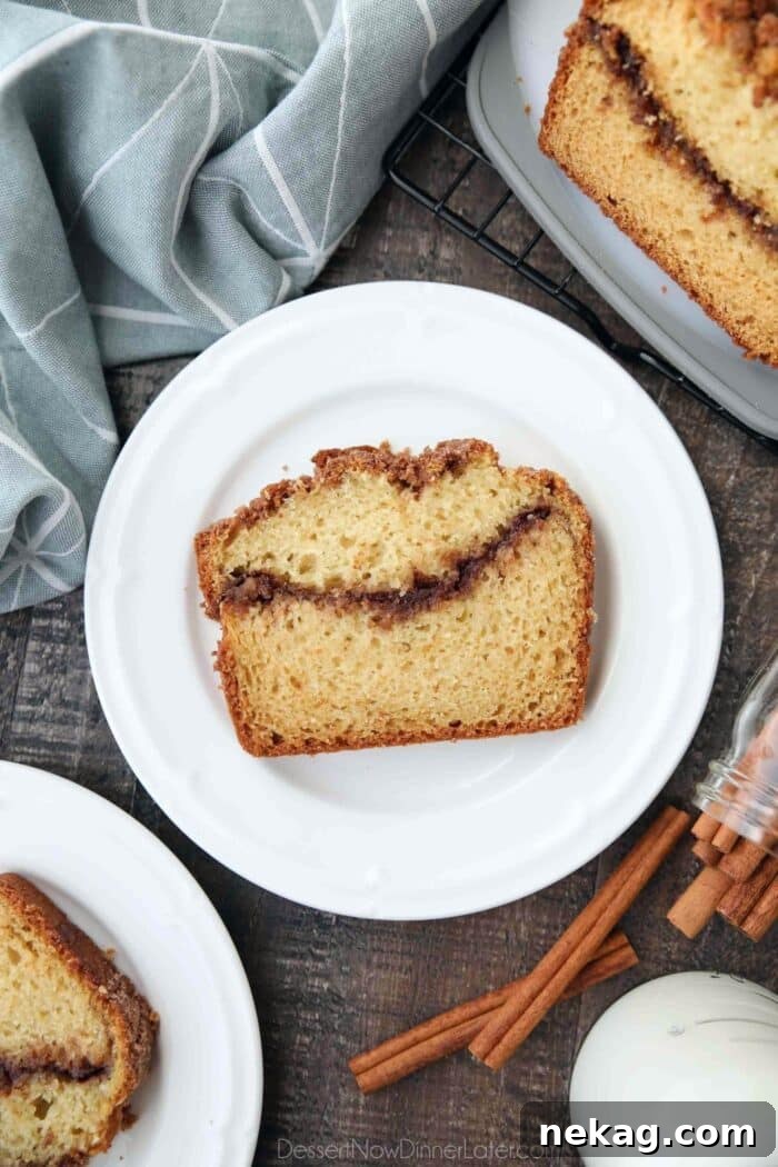Ultimate Cinnamon Quick Bread Recipe — Moist & Spiced Loaf 5 Slice of loaf cake with a cinnamon swirl center.