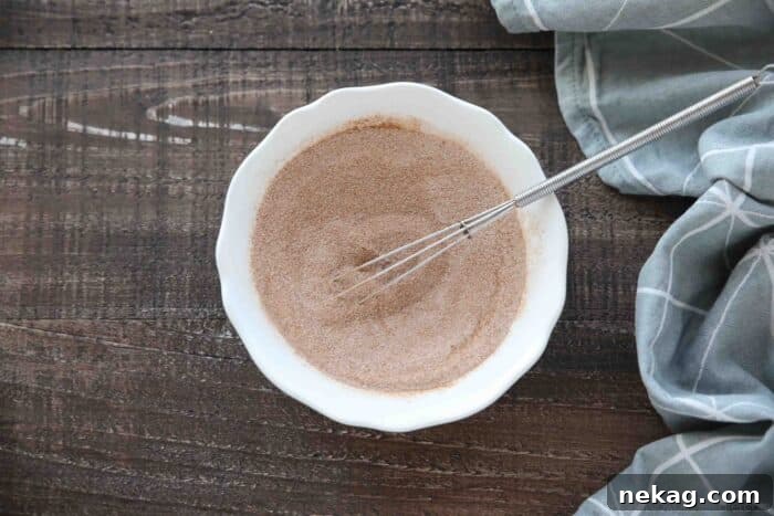 Ultimate Cinnamon Quick Bread Recipe — Moist & Spiced Loaf 7 Bowl of cinnamon-sugar being whisked together.