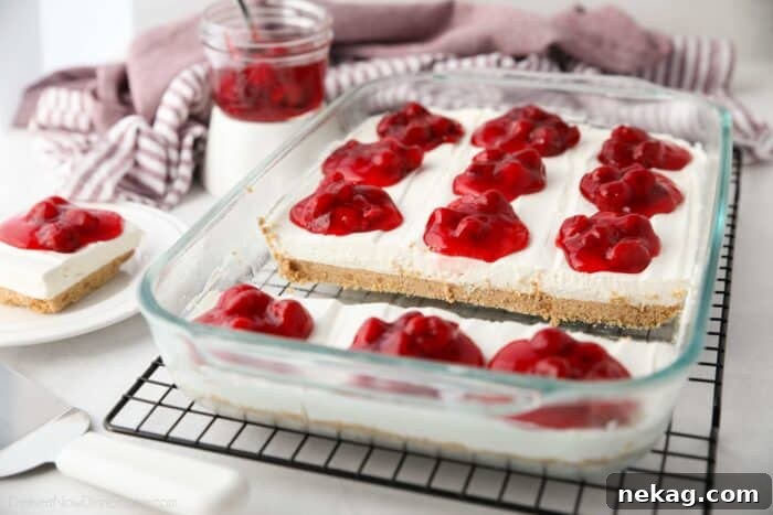 Cherry Delight recipe made in a 9x13 pan with some slices removed.