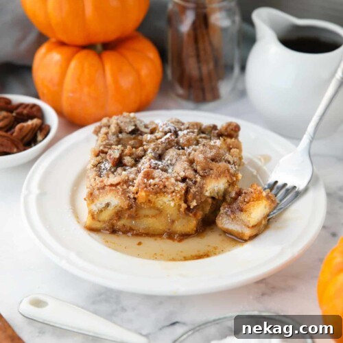 Piece of baked pumpkin French toast with a fork-full taken out.