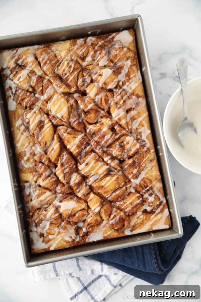 Top view of swirled cinnamon roll cake with a vanilla glaze drizzled over the top.