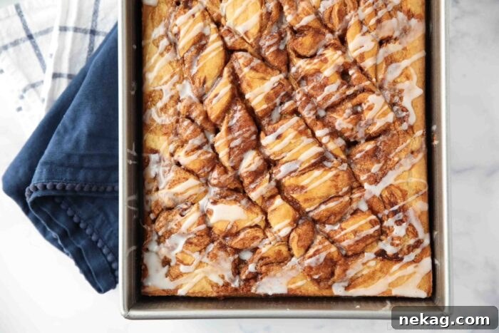 Top view of swirled cinnamon roll cake with a vanilla glaze drizzled over the top.