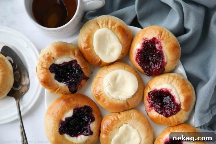 Variety of fruit and cream cheese kolaches on a platter.