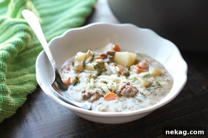 Close-up of cheeseburger soup showing chunks of potato and vegetables