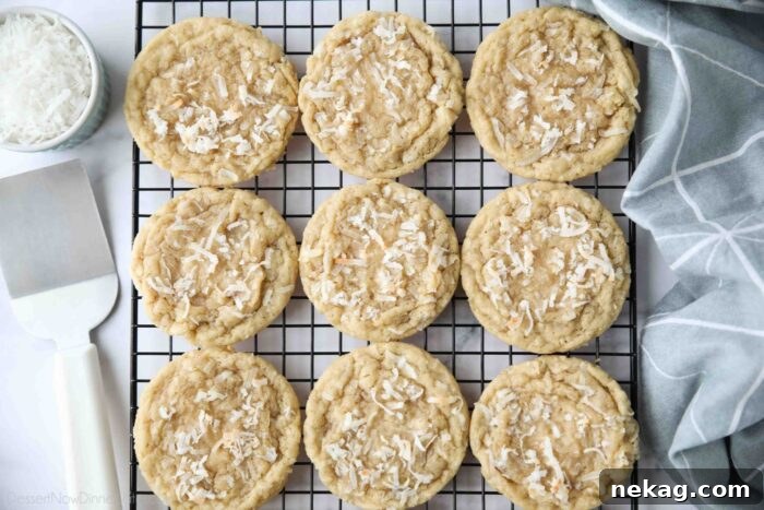 Chewy Coconut Cookies Recipe with Crispy Edges 8 Coconut cookies cooling on a wire rack.