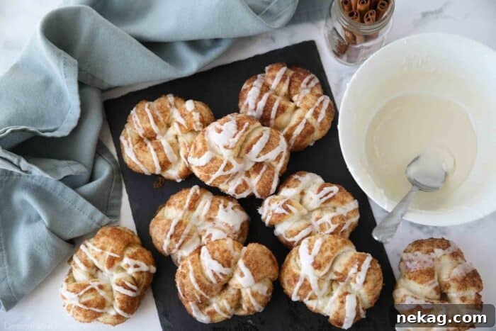 Cinnamon knots on a slate board with icing.