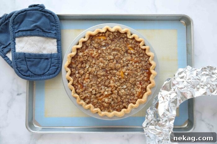 Freshly baked peach crumb pie straight out of the oven.