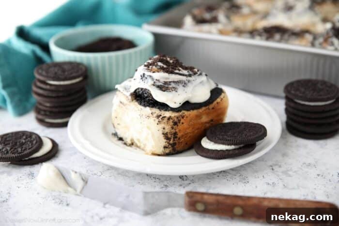 Oreo-Stuffed Cinnamon Rolls with Cream Cheese Glaze 11 Side view of an Oreo filled cinnamon roll with cream cheese frosting.