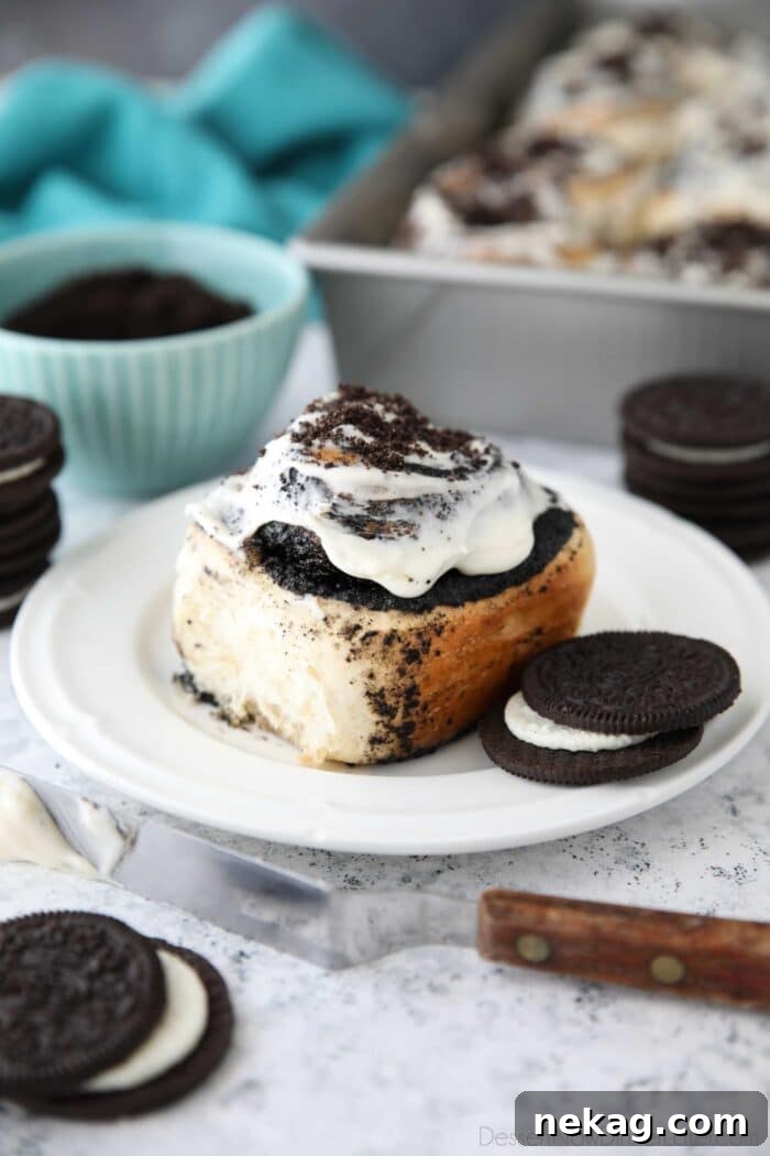 Oreo-Stuffed Cinnamon Rolls with Cream Cheese Glaze 4 Side view of an Oreo filled cinnamon roll with cream cheese frosting.