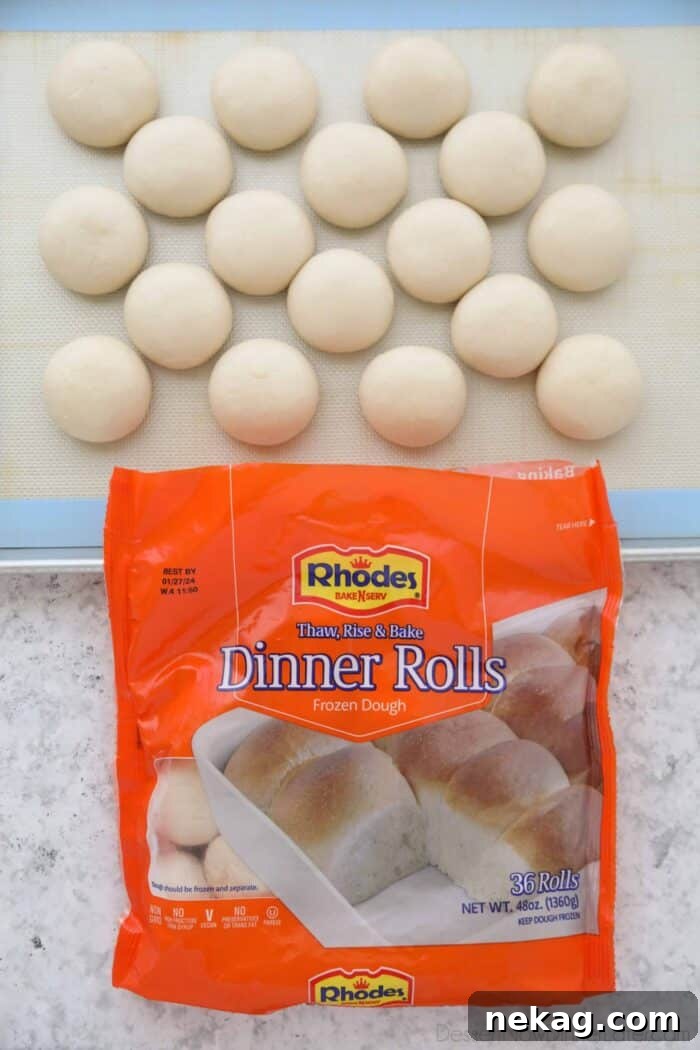 Oreo-Stuffed Cinnamon Rolls with Cream Cheese Glaze 5 Frozen Rhodes Dinner Rolls thawing on a sheet tray.