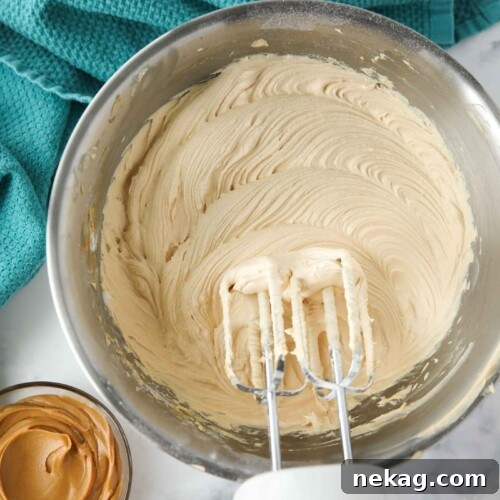 Creamy Peanut Butter Frosting Recipe for Cakes & Cupcakes 8 Bowl of peanut butter frosting made with an electric and mixer.