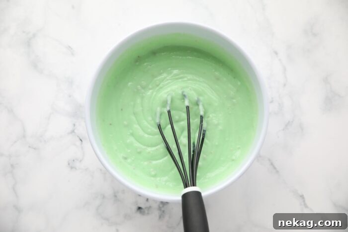 Decadent Pistachio Dessert Recipes to Impress Guests 9 Instant pistachio pudding being whisked in a bowl.