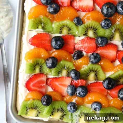 Top view of sugar cookie fruit pizza bars with cream cheese frosting.