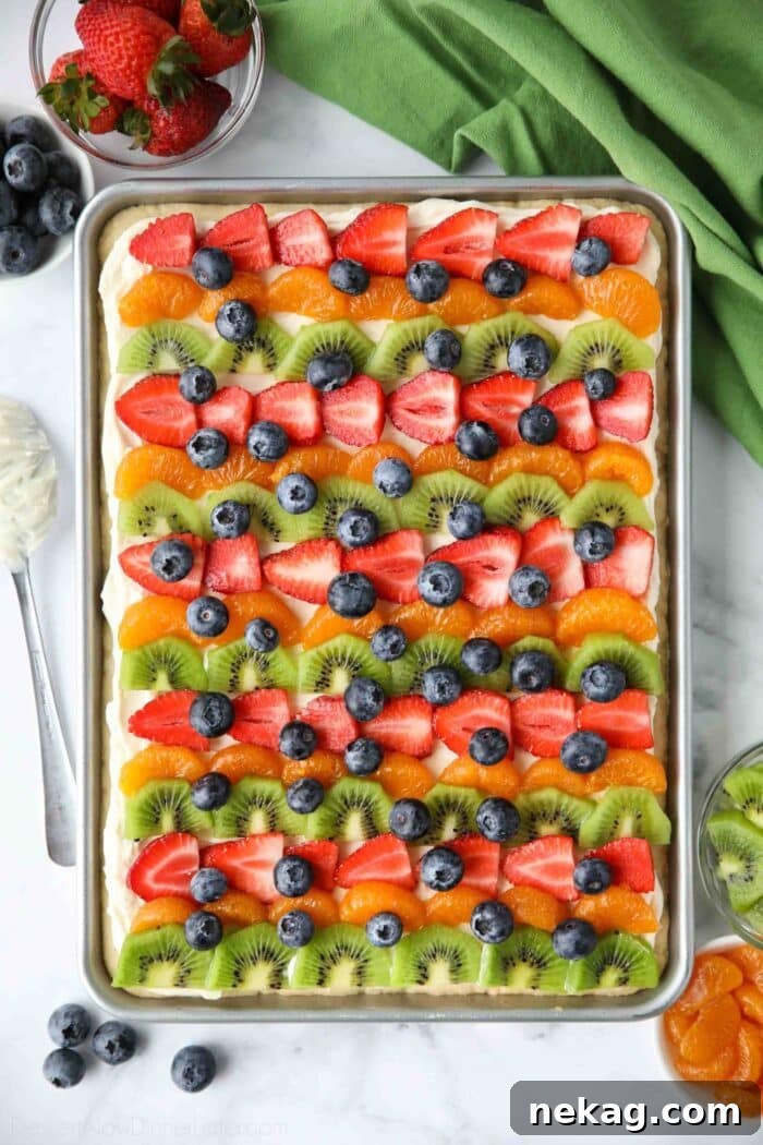 9x13 sugar cookie fruit pizza topped with different fruits.