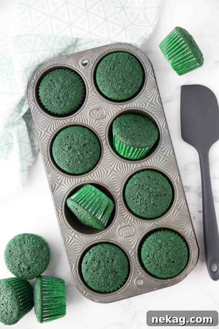 Baked green cupcakes in pan.