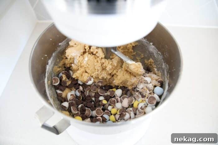 Cadbury Egg Cookie Recipe: Gooey Chocolate Candy Cookies 7 Adding chocolate chips and crushed mini Cadbury eggs to cookie dough.