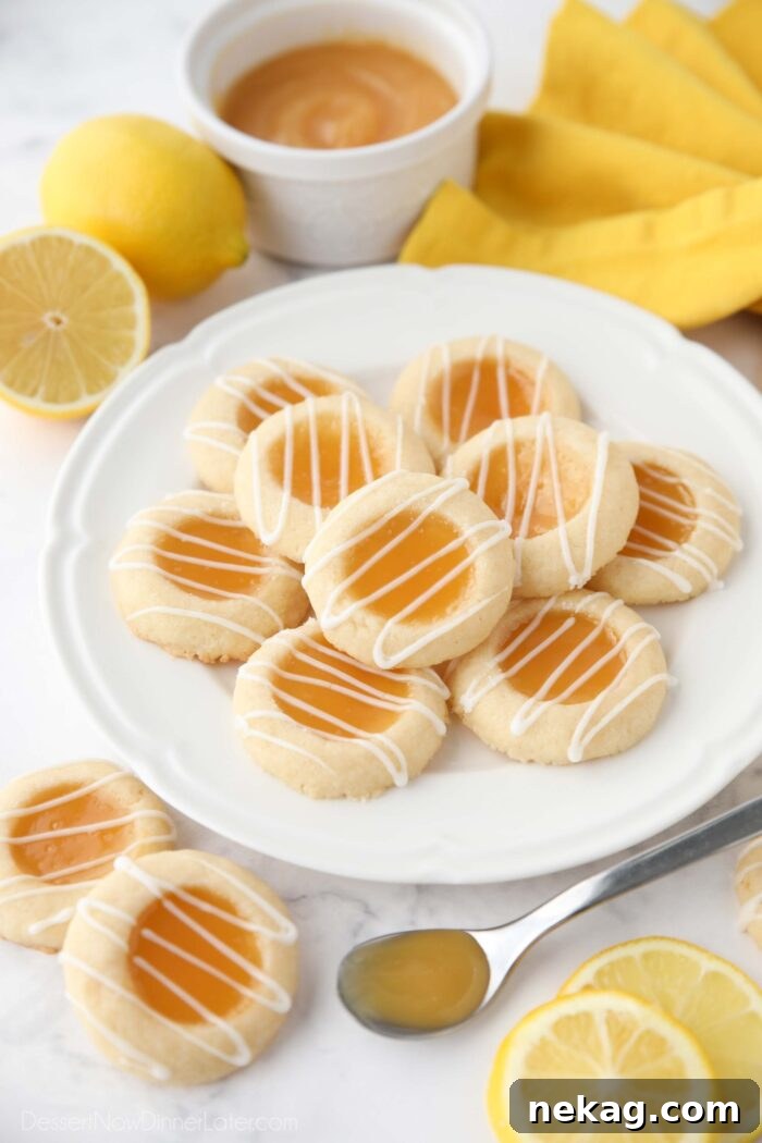Plate of lemon curd cookies with glaze drizzled on top.