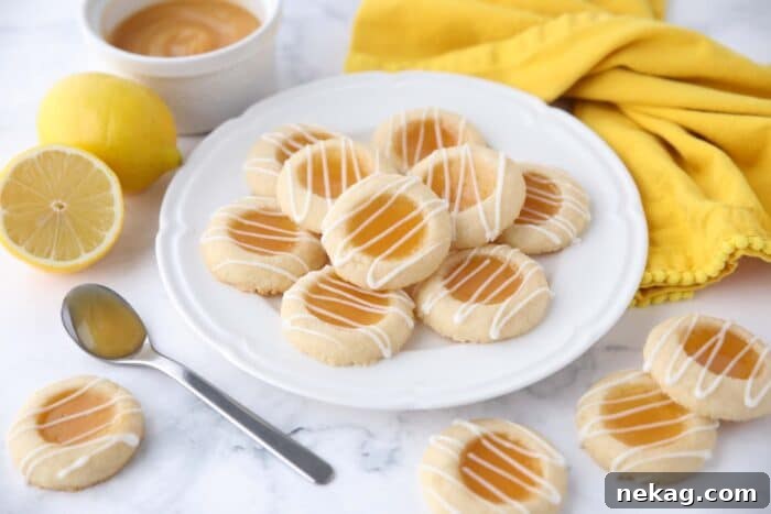 Plate of lemon curd cookies with glaze drizzled on top.