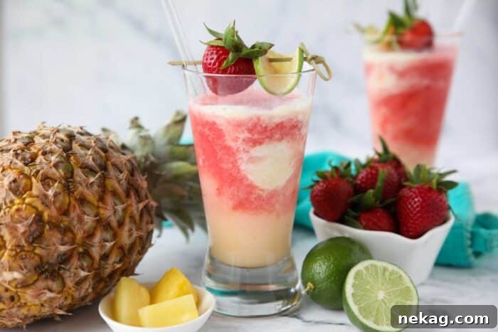 Two glasses of Miami Vice mocktail -- a mixture of non-alcoholic pina colada and strawberry daiquiri drinks swirled together.