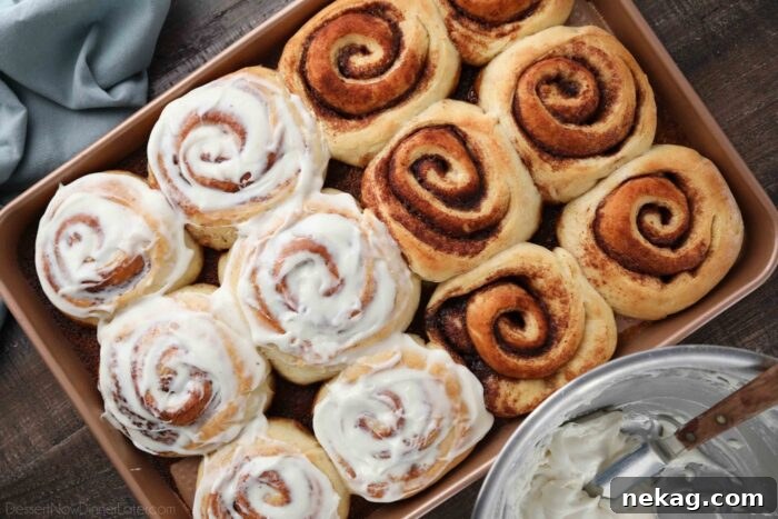 Homemade Cinnamon Rolls with Gooey Cream Cheese Frosting 12 Cinnamon rolls in a pan, half with frosting, and half without.