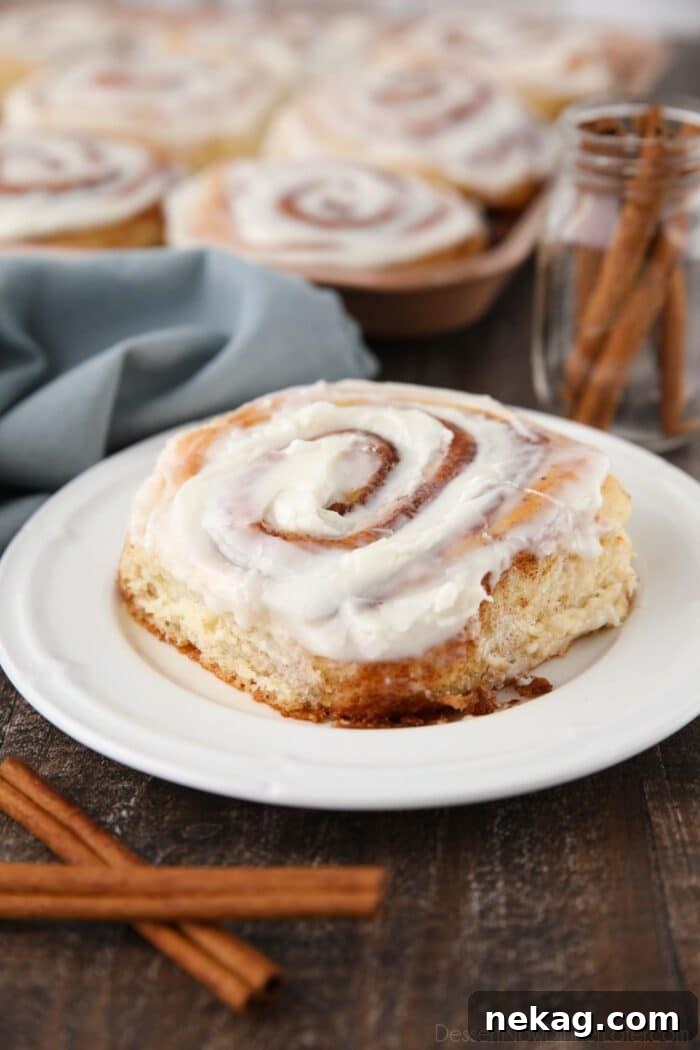 Homemade Cinnamon Rolls with Gooey Cream Cheese Frosting 3 One big cinnamon roll on a plate.