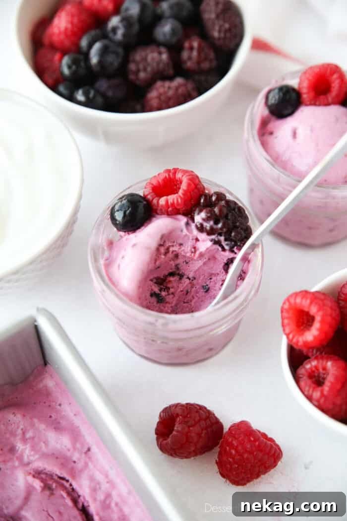 Close up of a small jar of berry frozen yogurt after some has been eaten.