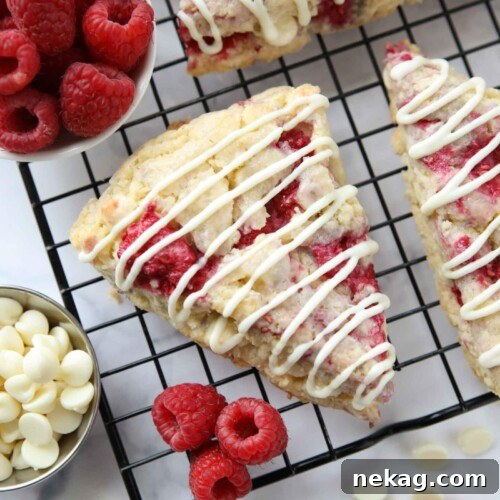 White chocolate raspberry scones on a wire cooling rack.