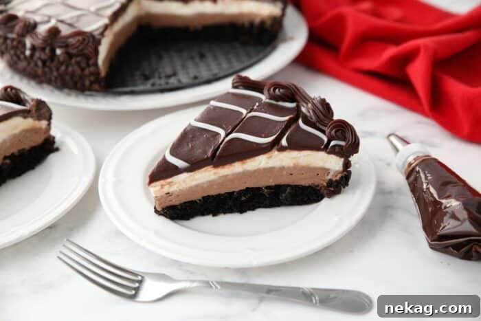 Decadent Black Tie Chocolate Mousse Cake Recipe 16 Slice of Olive Garden Black Tie Mousse Cake on a plate showing layers of chocolate cake, chocolate mousse, vanilla mousse, with swirled white and dark chocolate ganache on top.