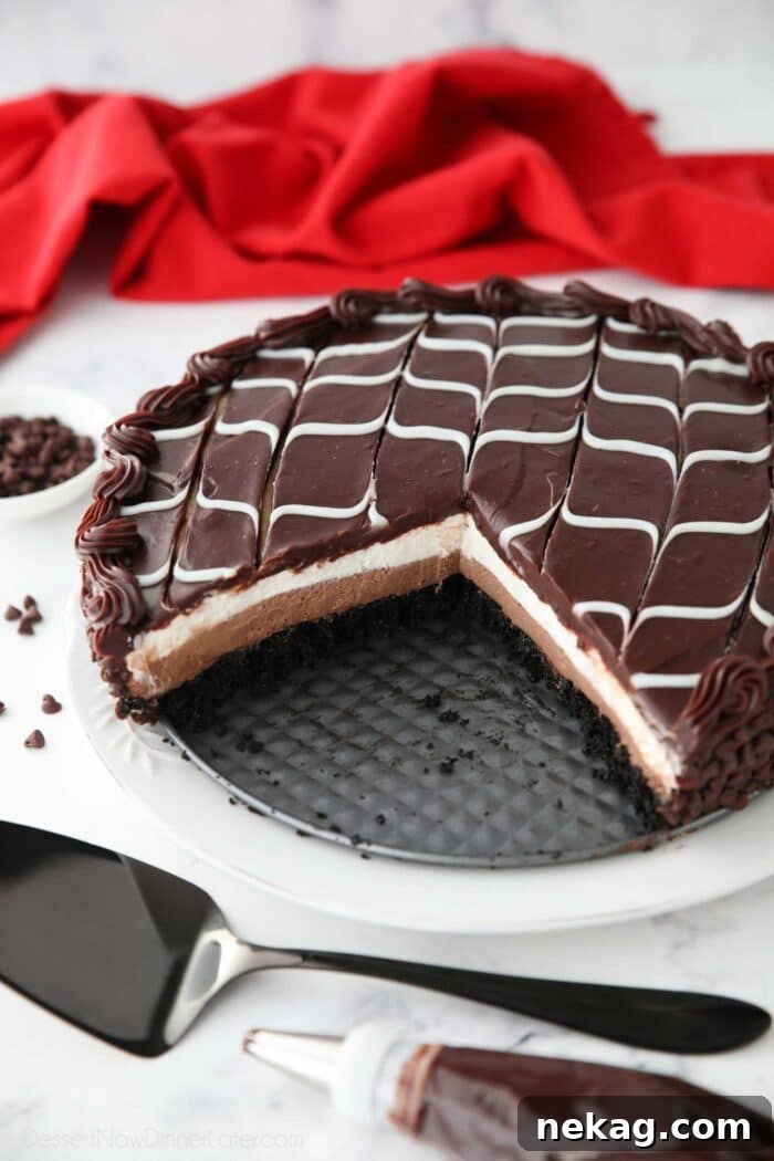 Decadent Black Tie Chocolate Mousse Cake Recipe 3 Copycat Olive Garden Black Tie Mousse Cake missing a couple of pieces to show layers of chocolate cake, chocolate mousse, vanilla mousse, with swirled white and dark chocolate ganache on top.