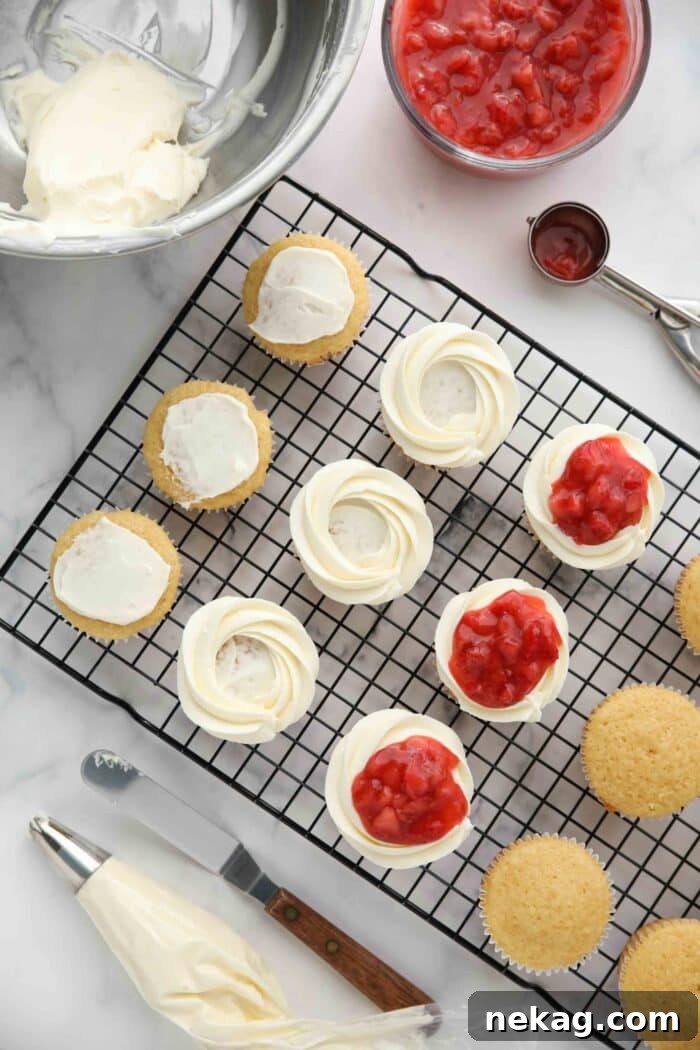 Strawberry Shortcake Cupcakes Recipe — Moist Strawberry Cupcakes 10 Topping vanilla cupcakes with whipped cream frosting and strawberry sauce to make strawberry shortcake cupcakes.