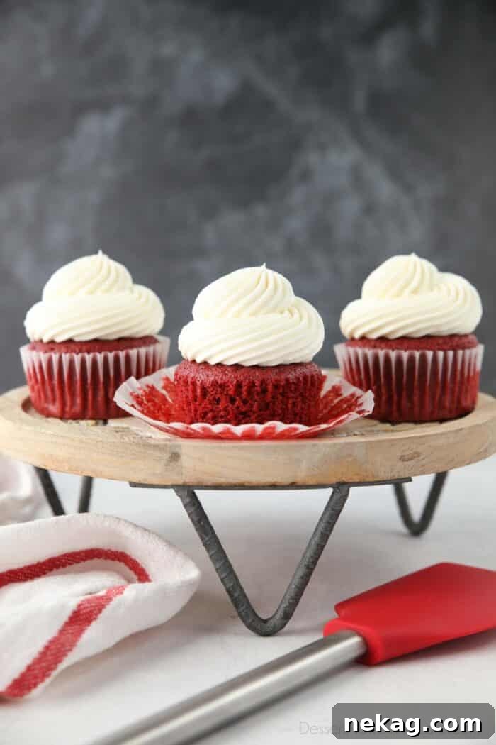 Red Velvet Cupcakes with cream cheese frosting on a cake stand.
