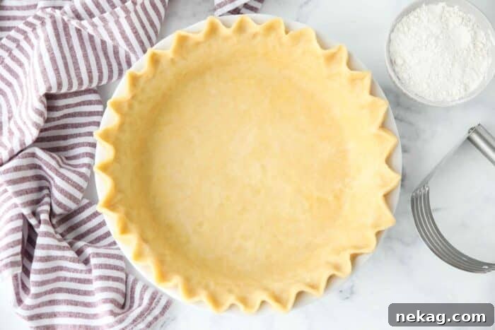 Top view of easy pie crust in a pan with fluted eges.
