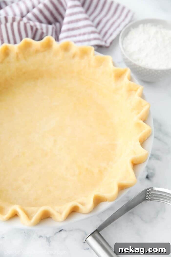 Close up of fluted edges of a shortening pie crust recipe.
