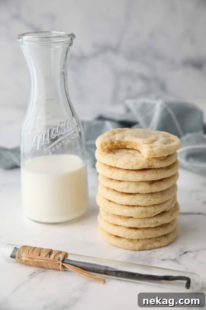 Classic Sugar Cookie Recipe: Soft, Bake-and-Share Cookies 3 Stack of basic sugar cookies next to a pitcher of milk.