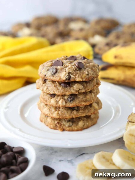 Stack of banana oatmeal chocolate chip cookies on a plate.