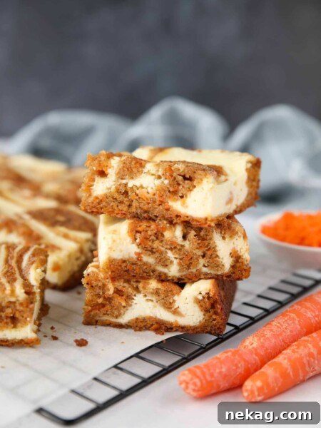 Carrot Cake Cheesecake Bars stacked on top of each other.