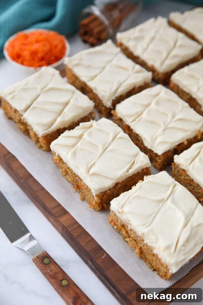 Top view of squares of carrot bars with frosting.