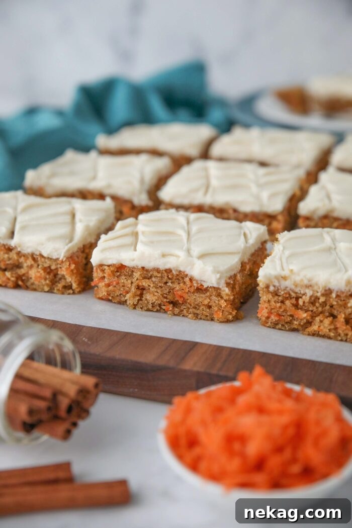Side view of squares of carrot bars with maple frosting.