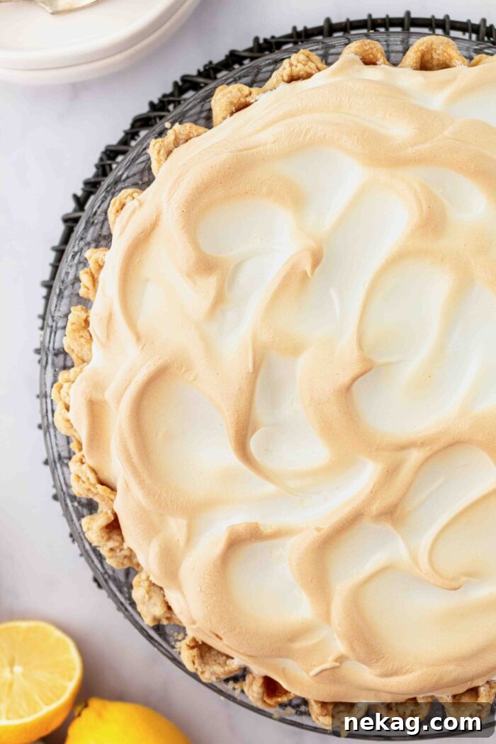 Classic Lemon Meringue Pie Recipe with Video Tutorial 11 Top view of toasted meringue on top of lemon pie filling in a pastry crust.