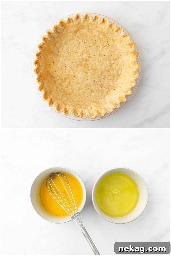 Classic Lemon Meringue Pie Recipe with Video Tutorial 7 Baked pie crust and two bowls of eggs divided into yolks and whites.