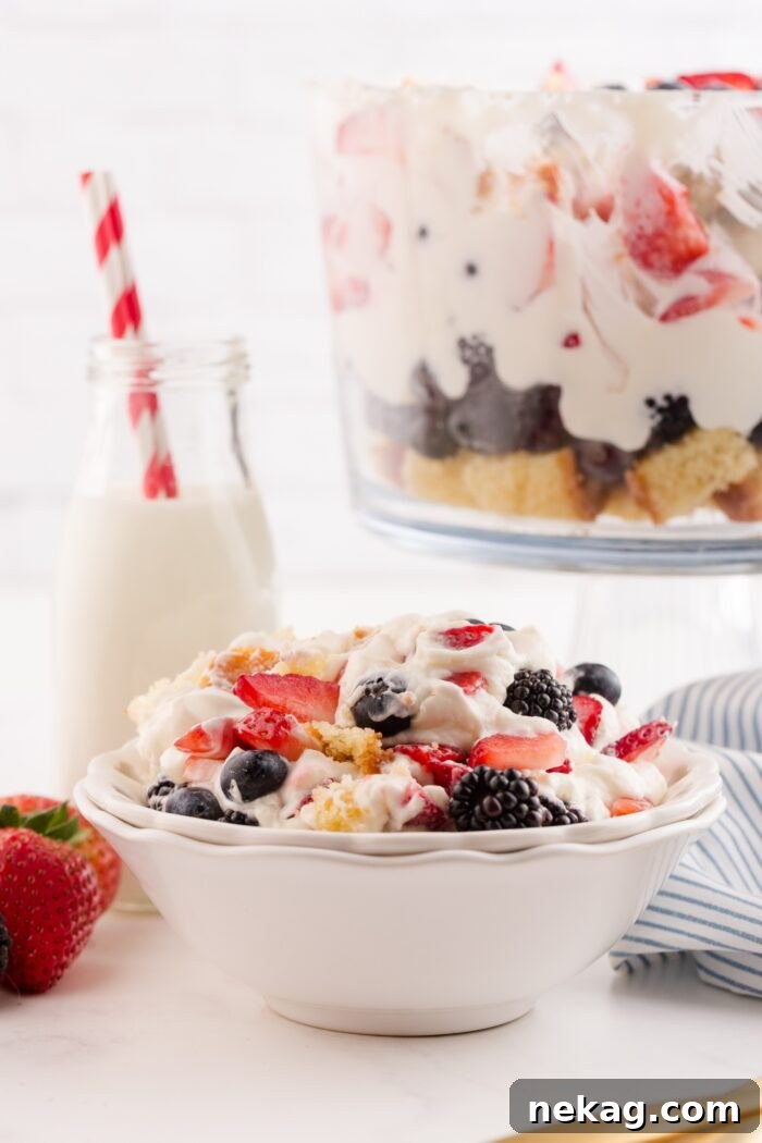 Red, White & Blue Berry Trifle Recipe with How-To Video 8 Red white and blue trifle scooped into a bowl.