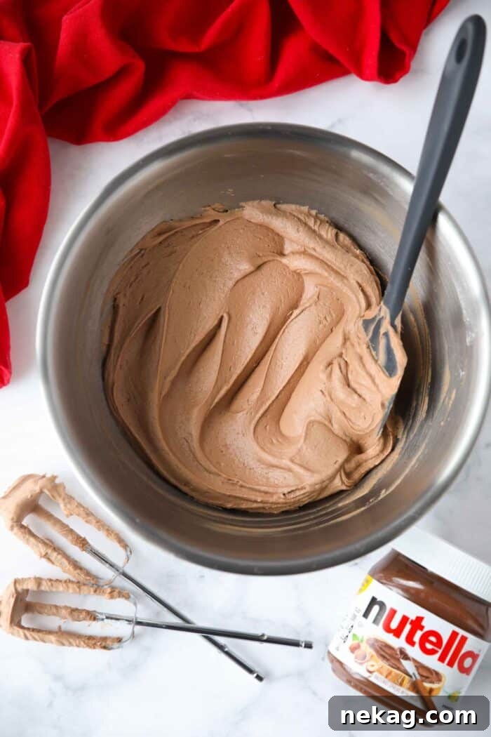 Bowl full of Nutella frosting swirled with a spatula.