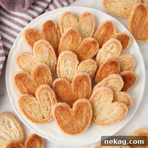 Two-Ingredient Palmiers: Crispy Puff Pastry Cookies 11 Top view of golden sugared palmiers on a plate.