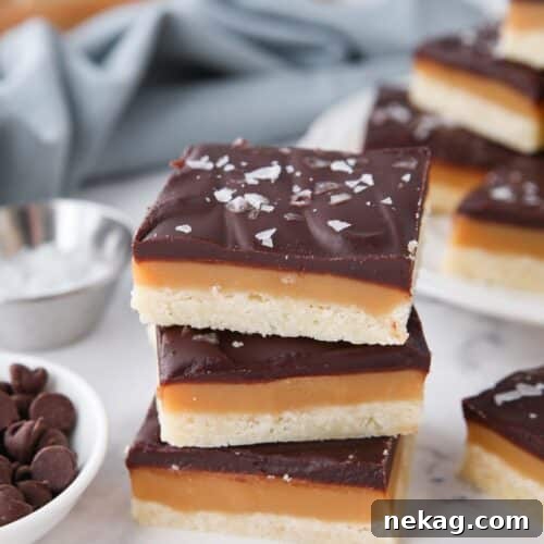 A stack of millionaire shortbread bars stacked on top of each other.